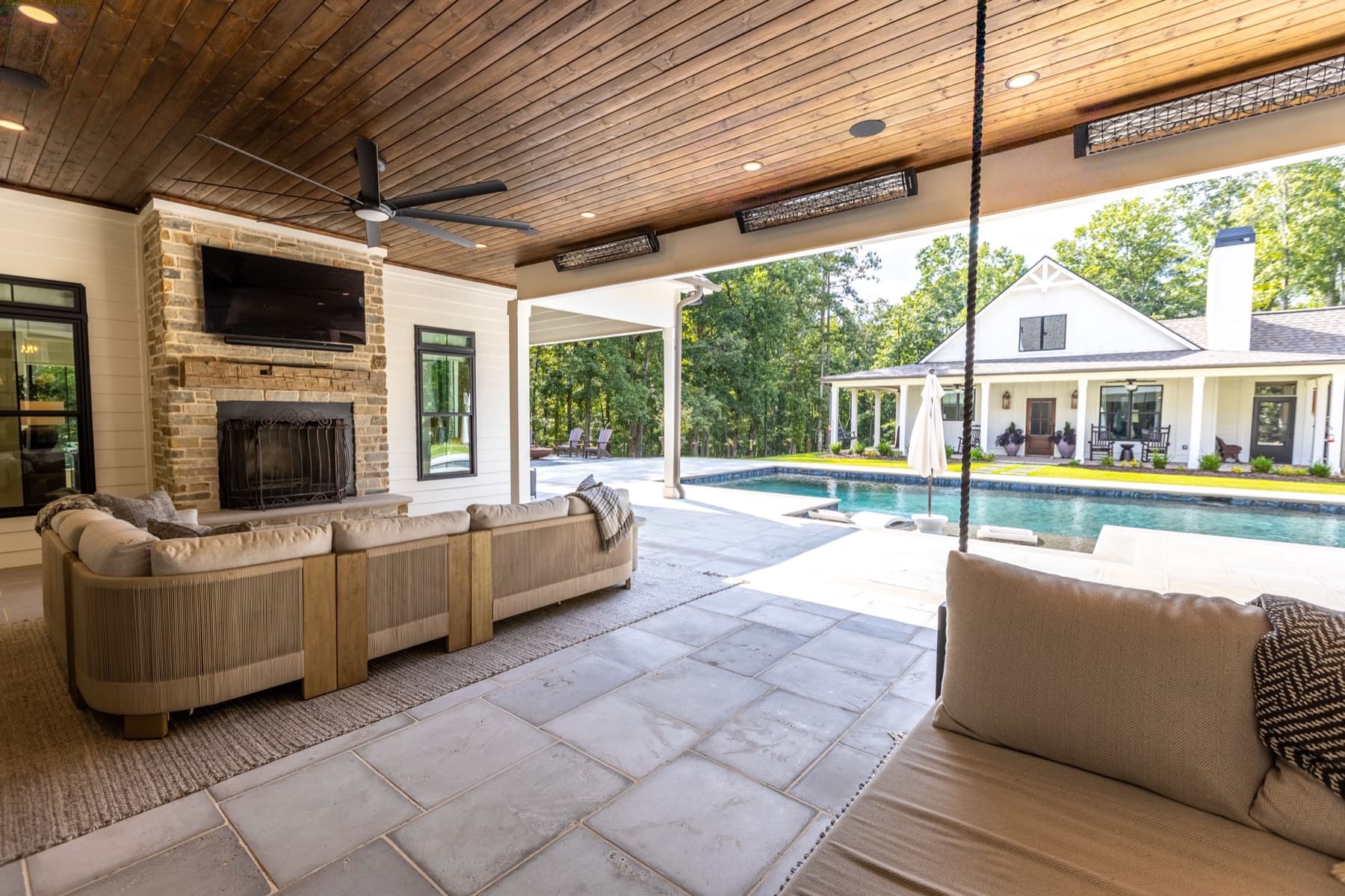 Outdoor living room with fireplace and pool